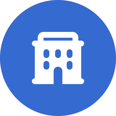 Icon of a white building with multiple windows and an arched entrance on a blue circular background.