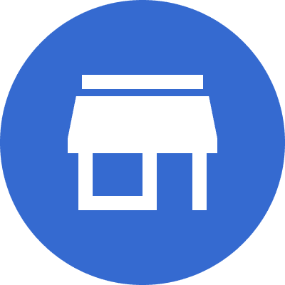 Icon of a store with a blue circular background. The store is represented in white with a simple rectangular design and a flat roof.